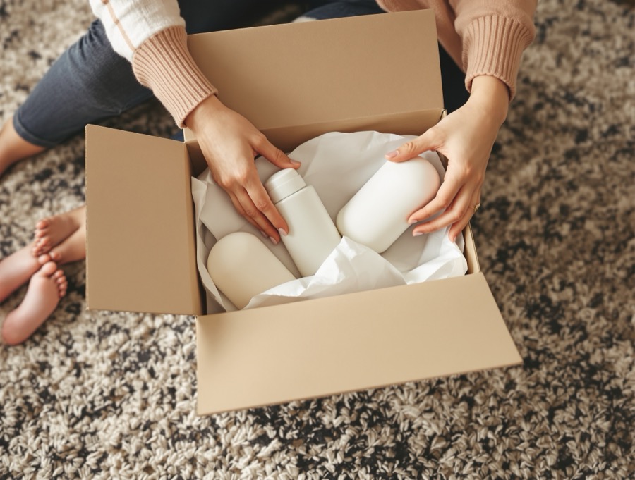 Hands opening a package with baby products